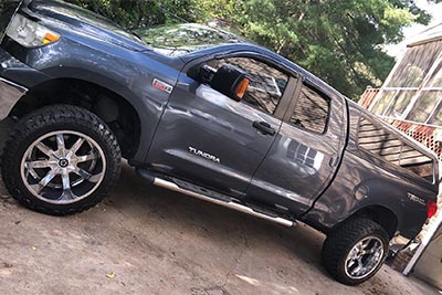 A dark gray Toyota Tundra truck with a Paradox Performance Muffler parked in a driveway.
